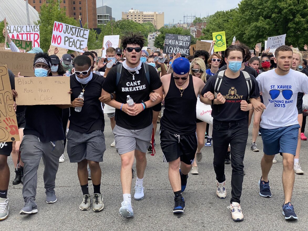 Demonstrators march through Uptown. Chants of "Whose streets? Our streets."